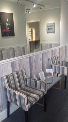 a waiting room with two chairs and a table at Duke of Buckingham in Portsmouth