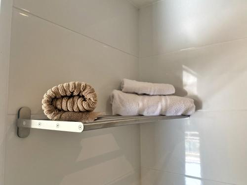 a shelf in a bathroom with towels on it at Villa Madeleine - Résidence Services Seniors in Nice