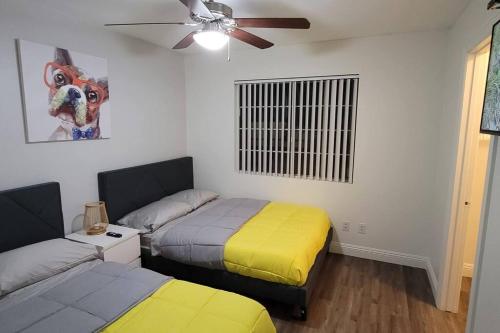 a bedroom with two beds and a ceiling fan at L - Fully remodeled and professionally decorated in Las Vegas
