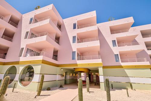 a building on the beach with cactus at Grand Paradiso Ibiza - Adults Only in San Antonio Bay