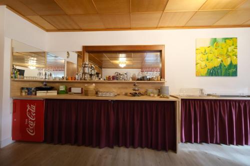 a bar with a coca cola counter in a room at Pension Hofmann in Oberasbach