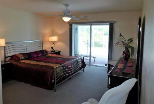 a bedroom with a bed and a sliding glass door at Maria Maria * vacation rental with amazing lake vi in Lehigh Acres