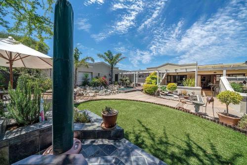 a person is standing on a patio with a yard at Kaya La Provence in Cape Town