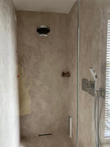 a shower with a glass door in a bathroom at Ceccarini 9 home suite home in Riccione