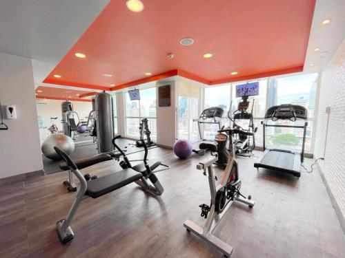 a gym with several treadmills and elliptical machines at Tryp by Wyndham Panama Centro in Panama City