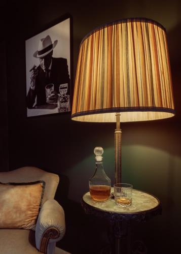 a lamp sitting on a table next to a chair at Cousins Boutique Hotel in Maastricht