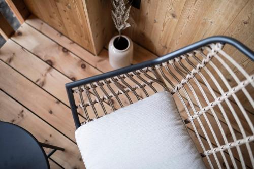 a white chair sitting in a room with a vase at Stadl Chalet oberhalb Brixen in Rosa