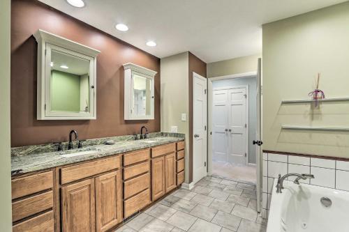 a bathroom with two sinks and a tub at Charles Town Home with Private Pool and Hot Tub in Charles Town