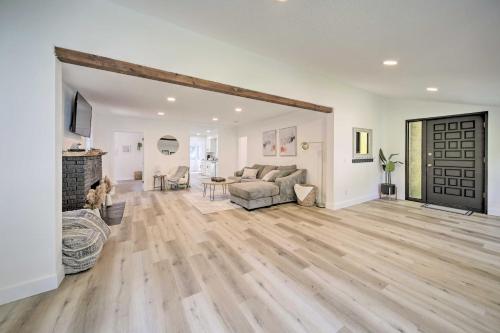 a living room with a couch and a fireplace at Bright and Airy Liberty Lake Abode with Backyard! in Liberty Lake