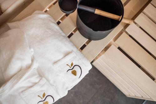 a pair of white towels with birds on them next to a bucket at Stadl Chalet oberhalb Brixen in Rosa