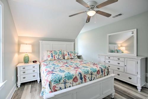 a bedroom with a bed and a dresser and a mirror at Modern Waveland Home with Deck, Walk to Beach! in Waveland