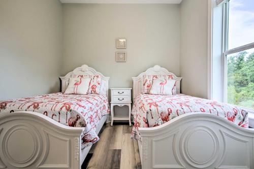 a bedroom with two beds and a window at Modern Waveland Home with Deck, Walk to Beach! in Waveland