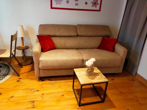 a living room with a couch and a table at L'oustalet de Mamy in Dourbies