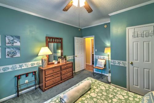 a bedroom with blue walls and a bed and a dresser at Beautiful Lakefront Retreat with Dock and Grill! in Littleton
