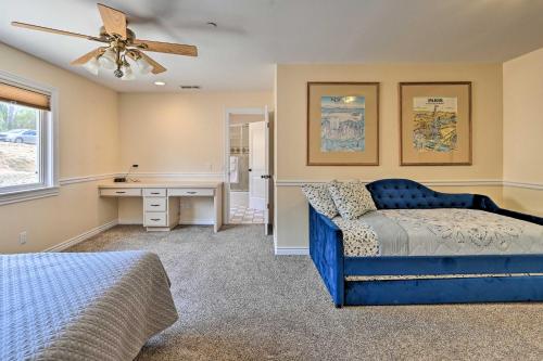 een slaapkamer met een blauw bed en een bureau bij Luxe Vista Getaway with Private Pool and Hot Tub! in Vista