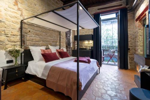 a bedroom with a canopy bed with red pillows at Palazzo Residenza Madre in Naples