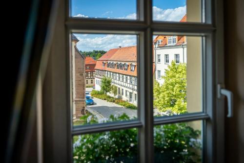 a window view of a city from a building at Hotel Reussischer Hof in Schmölln
