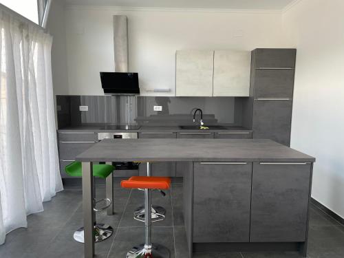 a kitchen with a counter and two stools at Villa 4 Princesses in Vela Luka