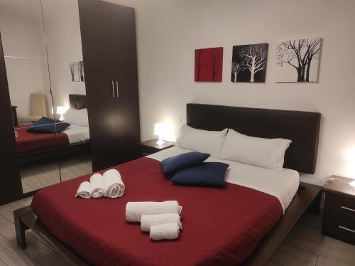 a bedroom with a large bed with towels on it at CASA ANNIO Holiday Viterbo in Viterbo