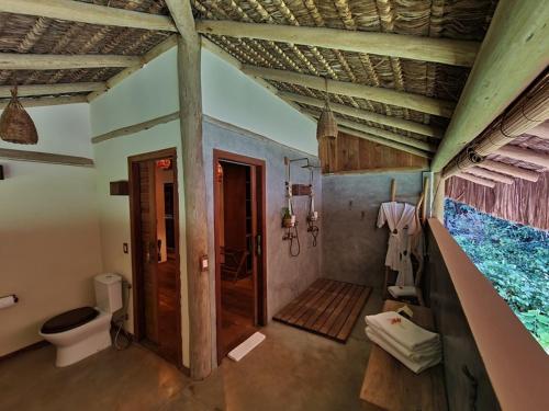 a bathroom with a shower and a toilet in it at Filha Da Lua Ecolodge in Pipa