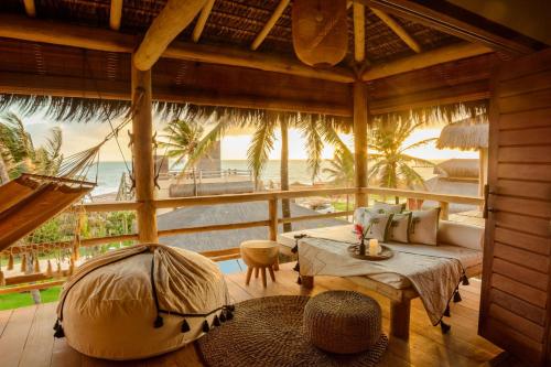 a living room with a view of the ocean at Filha Da Lua Ecolodge in Pipa
