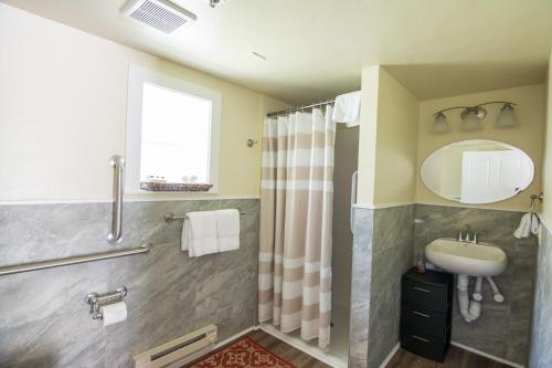 a bathroom with a shower and a sink at Yellowstone Hot Springs Resort in Gardiner