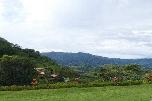 a green field with mountains in the background at Bungalows Sanlaz in Barrio Jesús