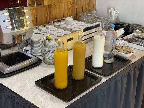 two bottles of orange juice on a tray on a kitchen counter at Buccaneers Boutique Guest House in St Paul's Bay