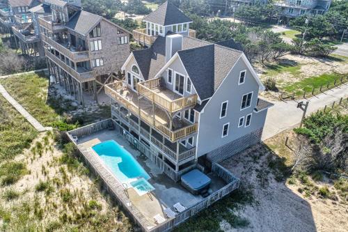 an aerial view of a house with a swimming pool at Play-N-Hooky Too #9-2 in Avon
