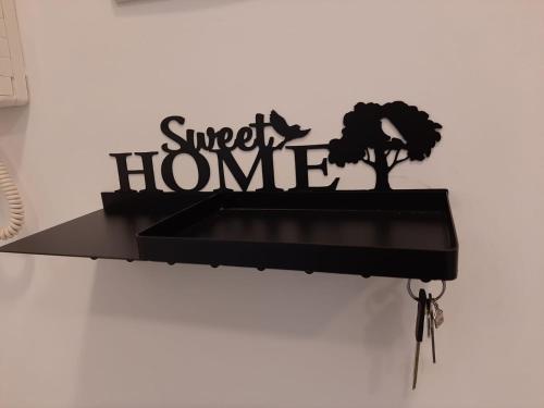 a black shelf with a sign that reads sweet home at Home Sweet Home in Civitavecchia