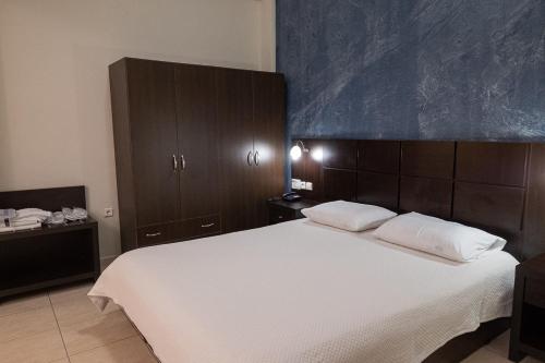 a bedroom with a large bed with two pillows at Democritus in Komotini
