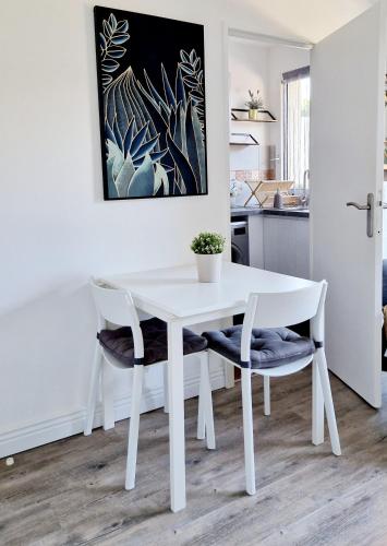 a white table and two chairs in a kitchen at HYPER CENTRE Gare RER A 250m Paris 20min in Poissy