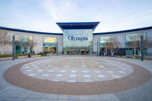 a large building with a sign that reads olympia at Penzion Village Peace #29 by Goodnite cz - U Libušky in Brno