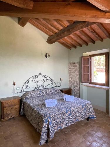 a bedroom with a bed in a room with a window at Villa Gosparini in Lisciano Niccone