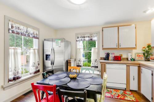a kitchen with a table and chairs and a refrigerator at Taylor Cottage in Savannah