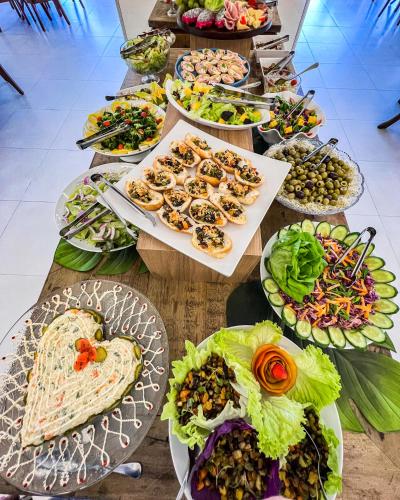 a table with many plates of food on it at Resort Ecoar in Gaspar