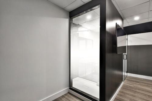a glass door in a room with a white wall at Hygie Boutique Hotel in Montreal