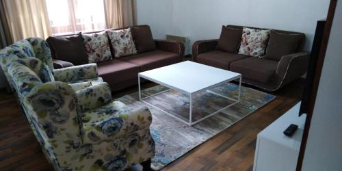 a living room with two couches and a table at Sarajevo city rent in Sarajevo