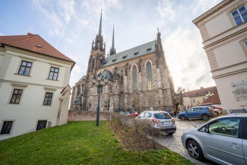a church with cars parked in front of it at Penzion Expo Dream #33 by Goodnite cz in Brno
