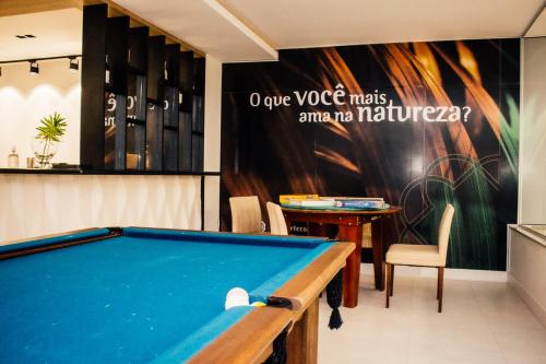 a pool table in a room with a sign at Resort Ecoar in Gaspar