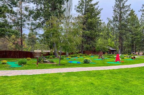 a playground in a park with green grass and trees at Alpine Escape in Bend