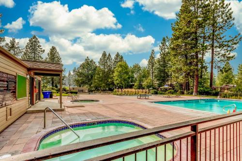 a hot tub on a deck next to a swimming pool at Alpine Escape in Bend