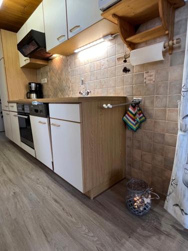 a kitchen with white cabinets and a counter top at Berghof am Schwand in Hinterhornbach