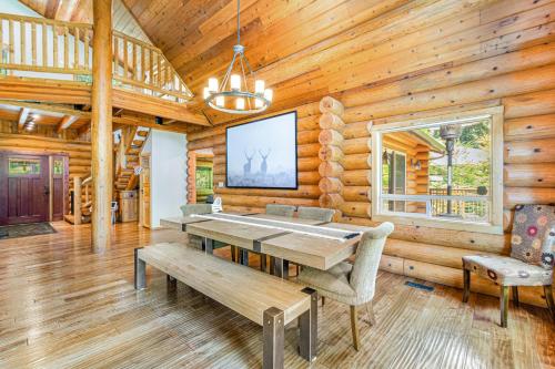 a dining room with a table in a log cabin at Alderbrook Grove in Union