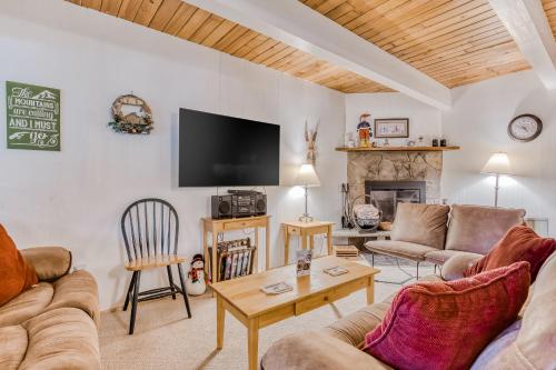 a living room with couches and a tv and a fireplace at Edelweiss Retreat in Government Camp