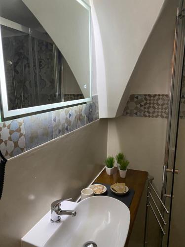 a bathroom with a sink and a mirror at Tama67 suite in Ostuni