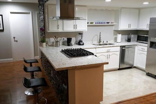 a kitchen with white cabinets and a counter top at T-Designed to ENJOY!. Best Vacation in Las Vegas