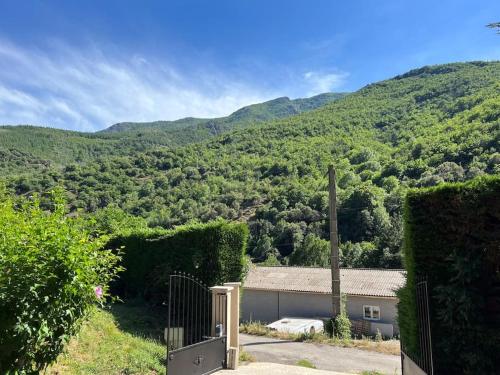 a house with a view of a mountain at Charmant Logement avec piscine. in Valleraugue