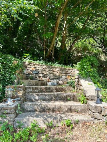 um conjunto de escadas de pedra num parque em Charmant Logement avec piscine. em Valleraugue