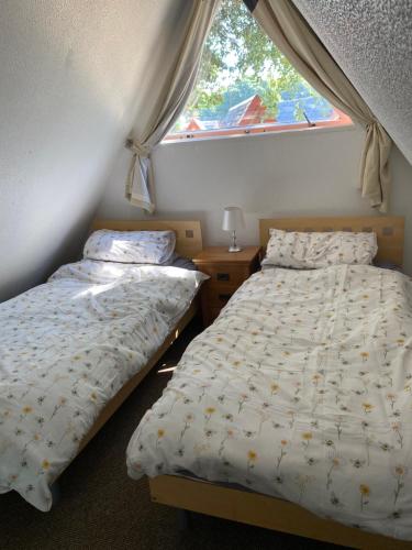 - 2 lits jumeaux dans une chambre avec fenêtre dans l'établissement Kingsdown Chalet, à Deal